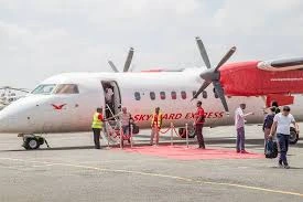 Passengers boarding a Skyward Express turboprop using the aircraft stairs