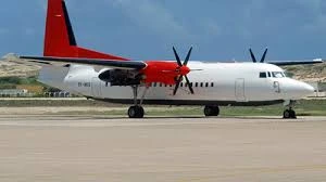 Skyward turboprop aircraft with red engines and tail parked on the airport apron