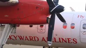 Close-up of a Skyward Airlines turboprop engine and propeller with red engine cowling